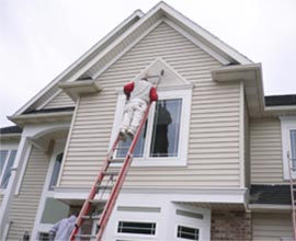 Painting the exterior of a contemporary house.